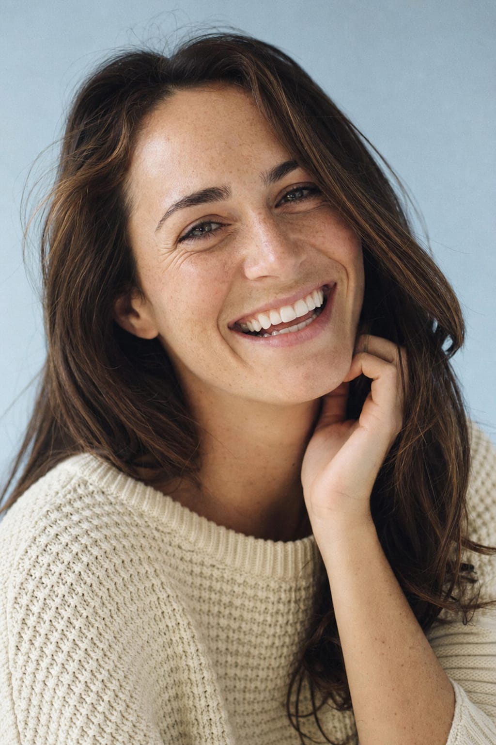 A patient of Square Dental laughing with a bright, healthy smile